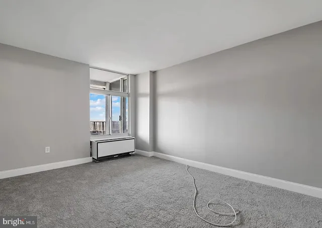 a view of empty room with air conditioner and window