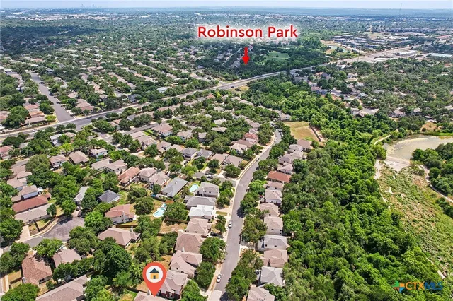 an aerial view of a houses with a city view