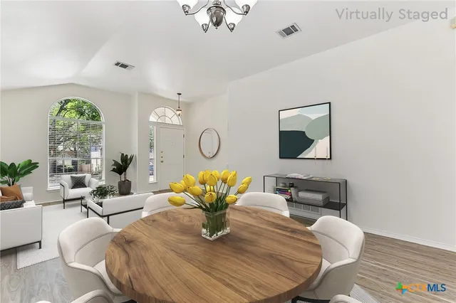 a living room with fireplace furniture and a large window
