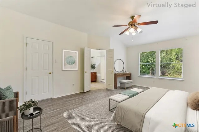 a bed room with a bed mirror and a window