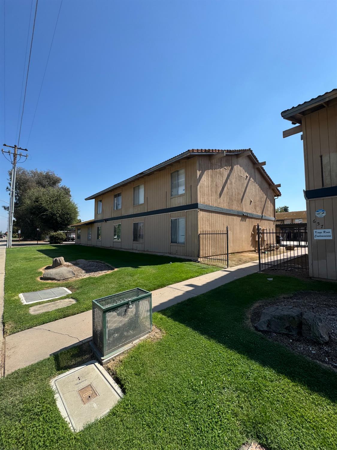 657 West Parlier Avenue, Unit 107 Reedley, CA 93654 - Photo 2 of 3 a view of a house with backyard sitting area and garden