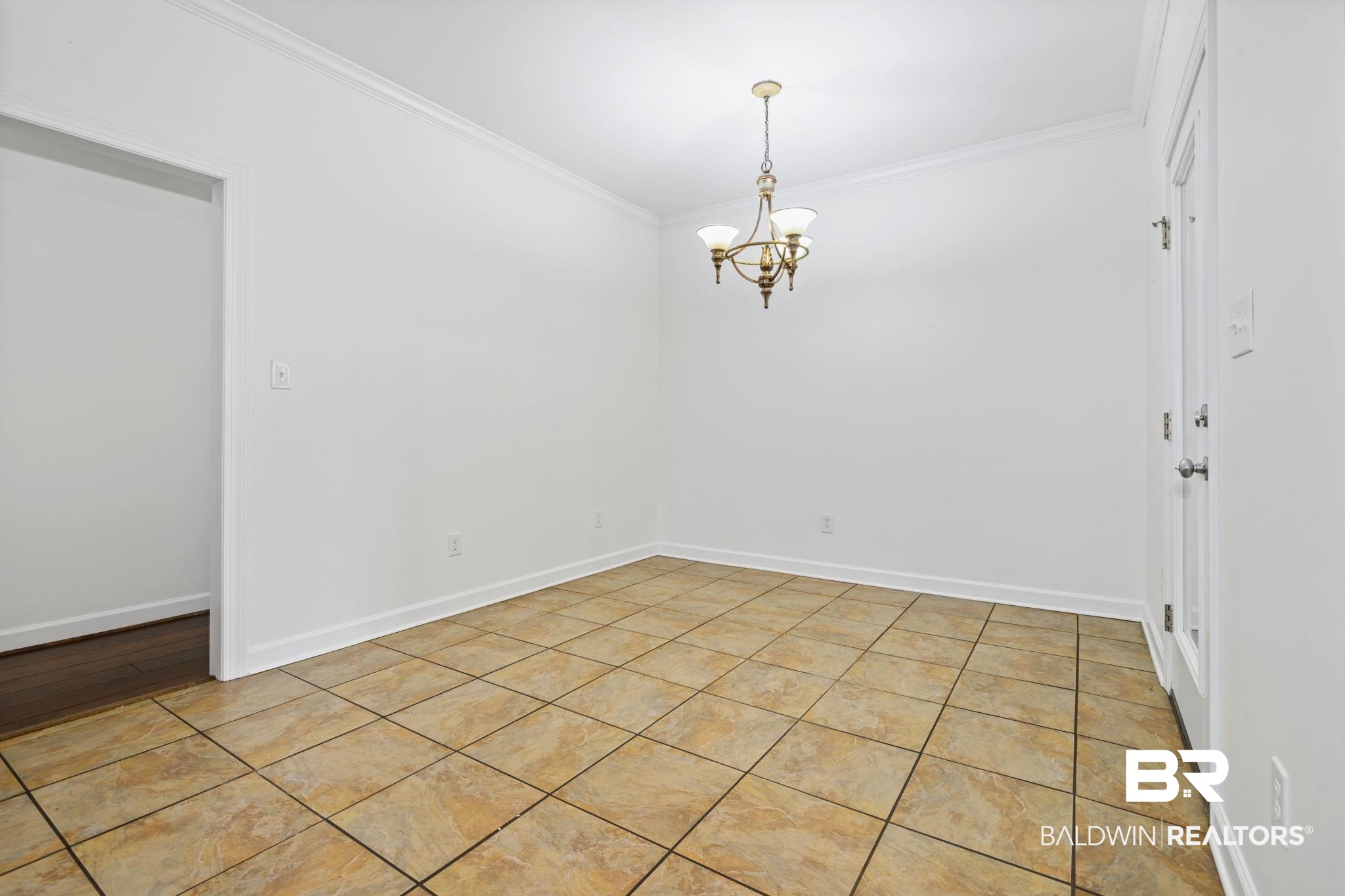 9730 Harmony Ridge Circle West Semmes, AL 36575 - Photo 6 of 38 Spare room featuring crown molding, a chandelier, baseboards, and light tile patterned flooring