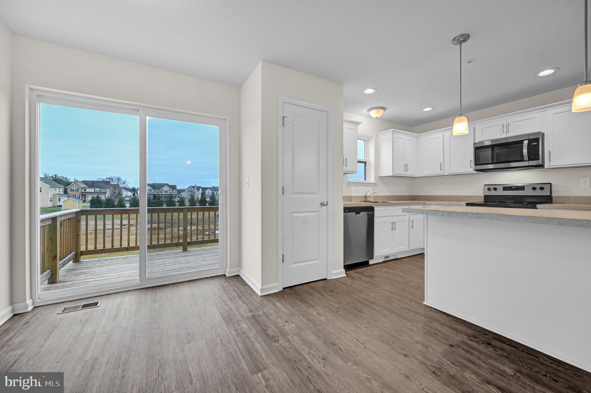 20 Landing Place, Unit 20 York, PA 17408 - Photo 9 of 27 a kitchen with granite countertop a stove a sink and a refrigerator