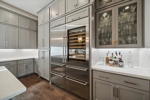 a kitchen with a refrigerator and cabinets