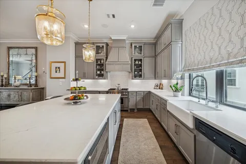 a large kitchen with a large counter top appliances and cabinets
