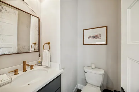 a bathroom with a toilet sink and mirror