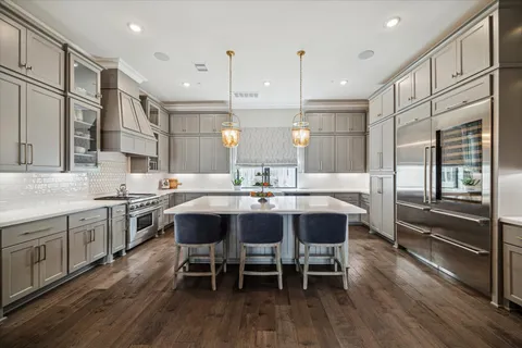 a large kitchen with a table and chairs
