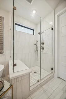 a bathroom with a shower sink and mirror