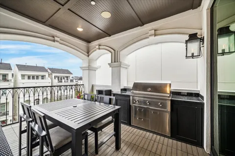 a kitchen with stainless steel appliances wooden floor dining table and chairs