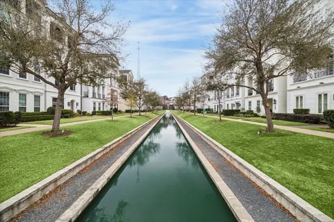 a view of residential houses with outdoor space and trees