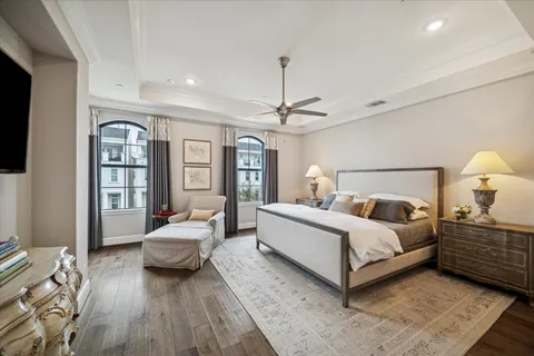 a spacious bedroom with a bed window and a couch