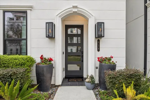 a front view of a house with a garden