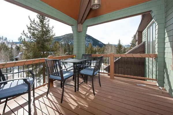 a view of a patio with a table chairs and a backyard
