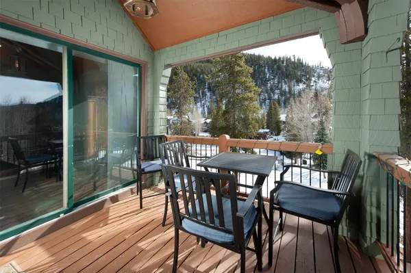a view of balcony with wooden floor and outdoor seating