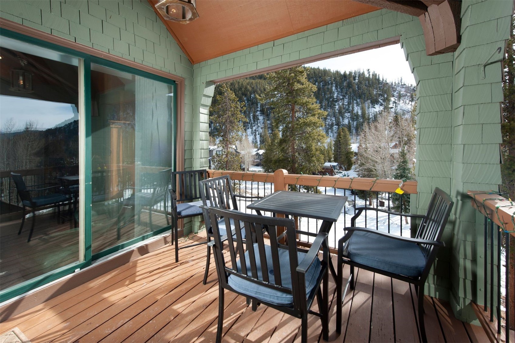 352 Wild Irishman Road, Unit 1907 Keystone, CO 80435 - Photo 14 of 43 a view of a patio with a table chairs and a backyard