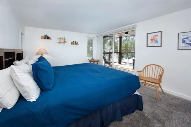 a bedroom with a bed a chair and a dresser