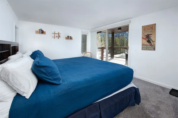 a bed room with a bed and a chair