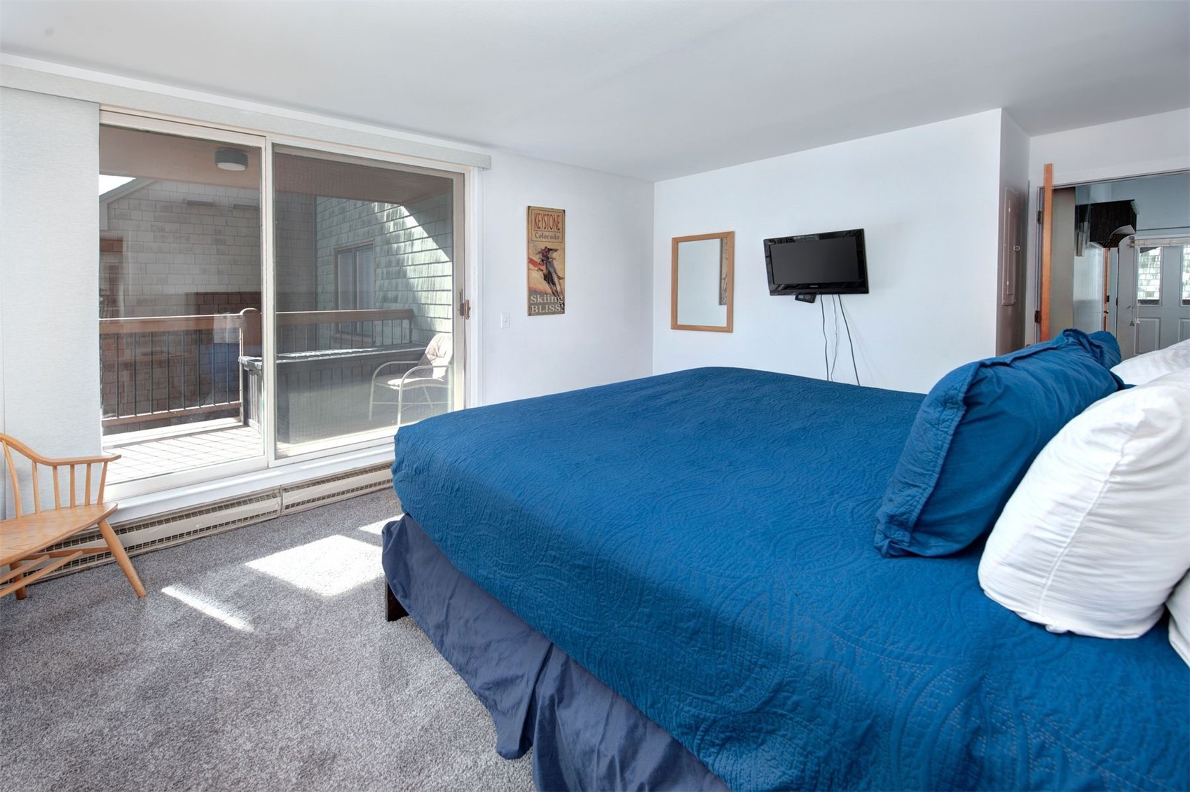 352 Wild Irishman Road, Unit 1907 Keystone, CO 80435 - Photo 20 of 43 a bedroom with a bed and a flat tv screen on dresser