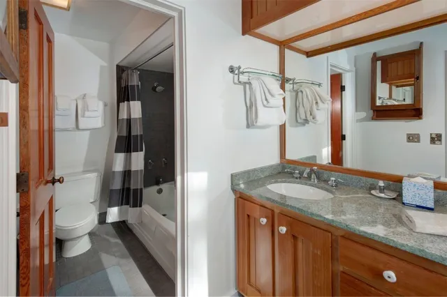 a bedroom with a bed and large window