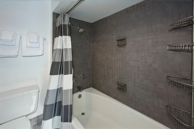 a bed sitting in a bedroom next to a book shelf