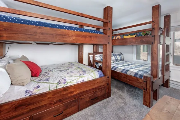 a bed sitting in a bedroom next to a window