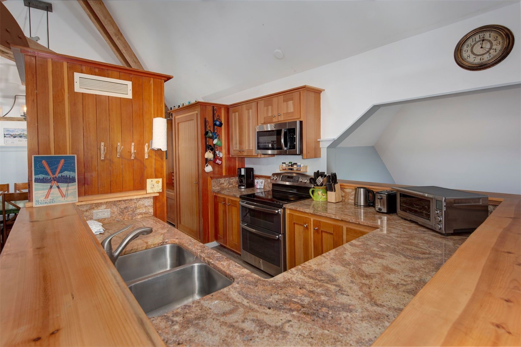 352 Wild Irishman Road, Unit 1907 Keystone, CO 80435 - Photo 6 of 43 a kitchen with stainless steel appliances granite countertop a sink dishwasher stove and refrigerator with wooden floor