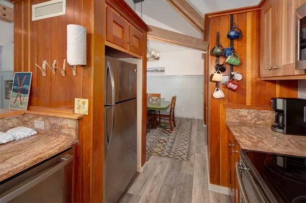 a kitchen with stainless steel appliances granite countertop a refrigerator and a sink