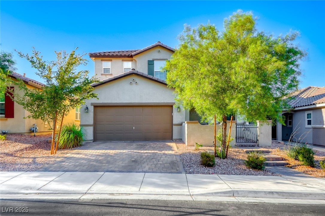 723 Gorringe Ridge Court Henderson, NV 89002 - Photo 1 of 48 Mediterranean / spanish home with a gate, decorative driveway, stucco siding, a garage, and a tiled roof