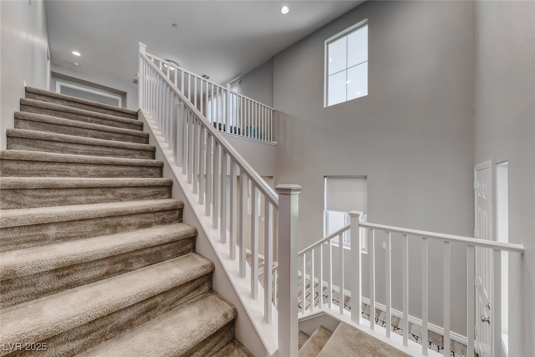 723 Gorringe Ridge Court Henderson, NV 89002 - Photo 19 of 48 Staircase featuring a high ceiling and recessed lighting