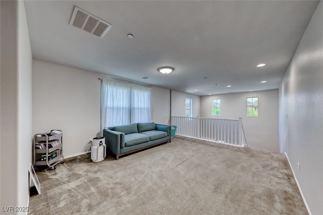 723 Gorringe Ridge Court Henderson, NV 89002 - Photo 20 of 48 Living area with carpet floors, plenty of natural light, an upstairs landing, and recessed lighting