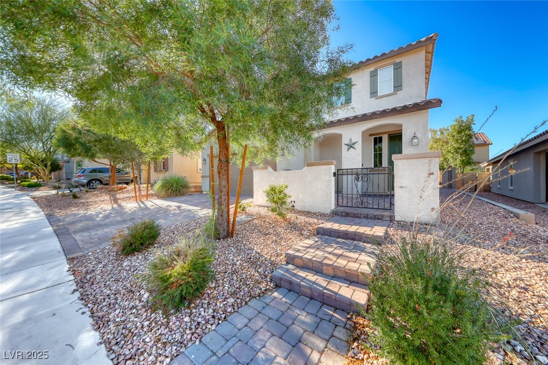723 Gorringe Ridge Court Henderson, NV 89002 - Photo 2 of 48 Mediterranean / spanish-style house with stucco siding, a gate, a fenced front yard, covered porch, and a tiled roof