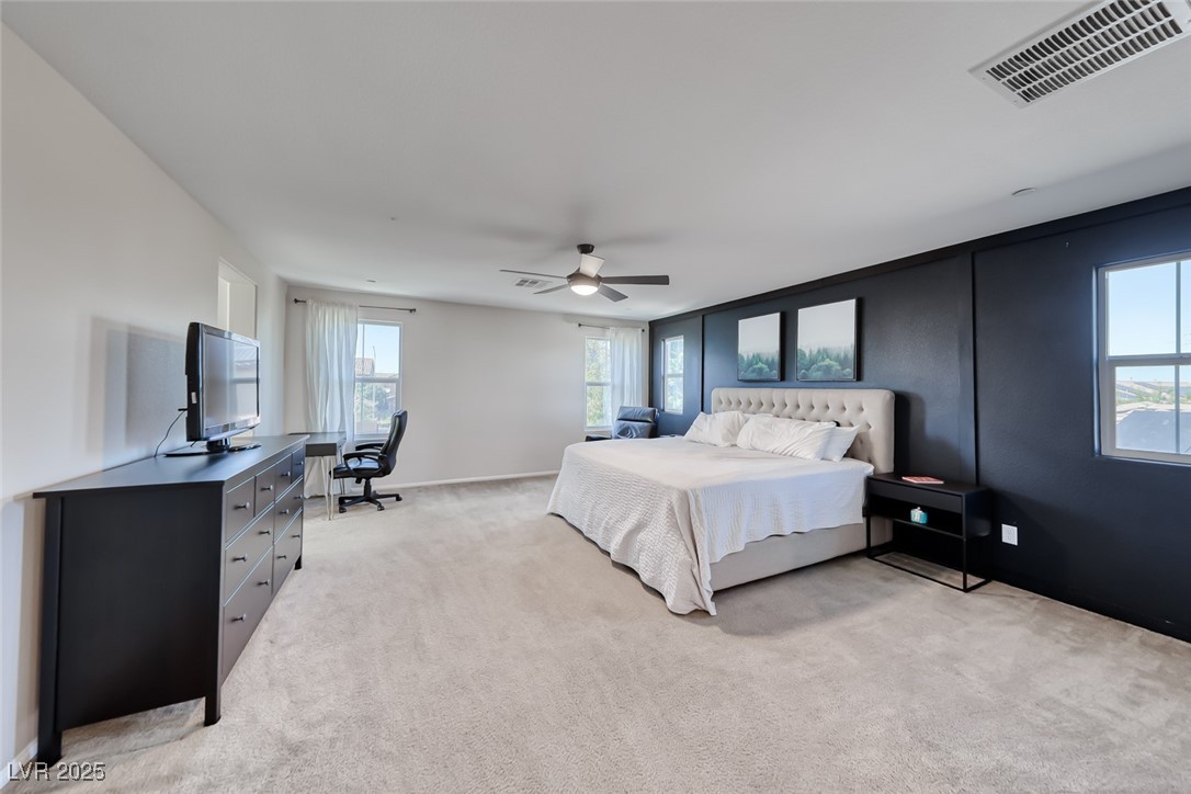 723 Gorringe Ridge Court Henderson, NV 89002 - Photo 22 of 48 Bedroom featuring a desk, multiple windows, light carpet, and ceiling fan