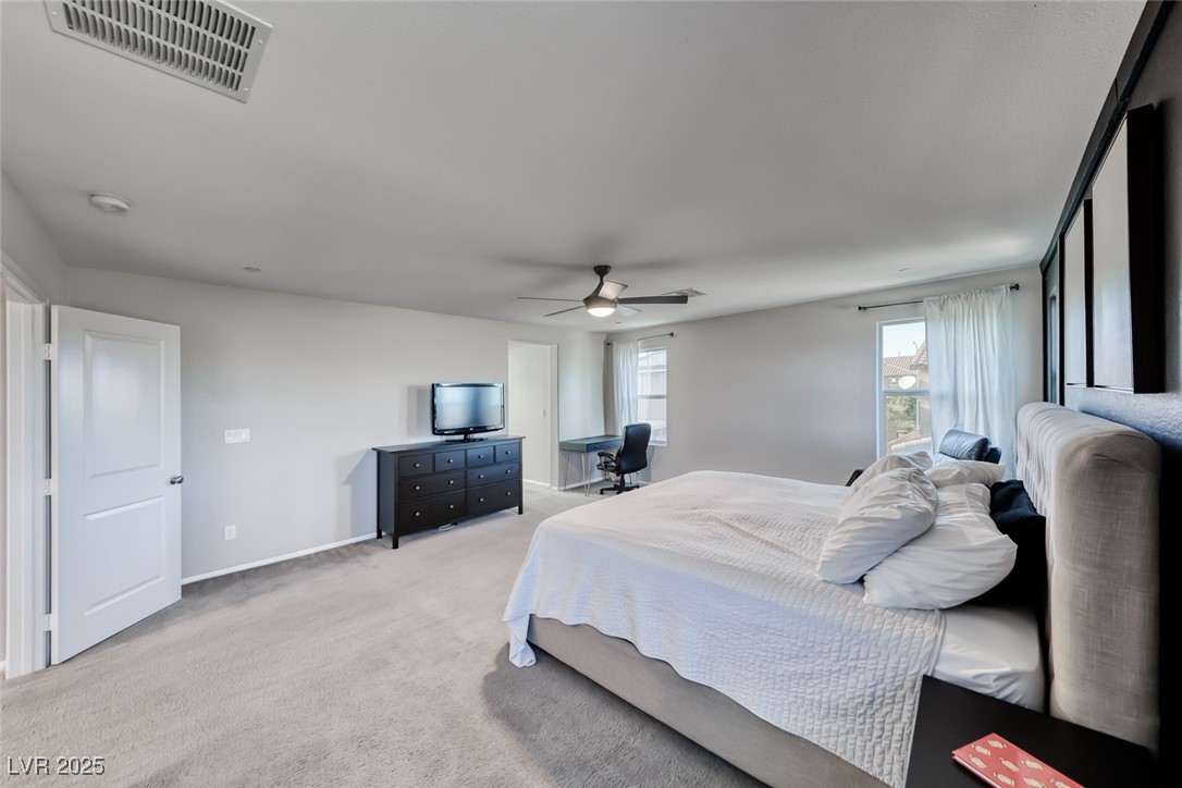 723 Gorringe Ridge Court Henderson, NV 89002 - Photo 23 of 48 Bedroom featuring light colored carpet and ceiling fan