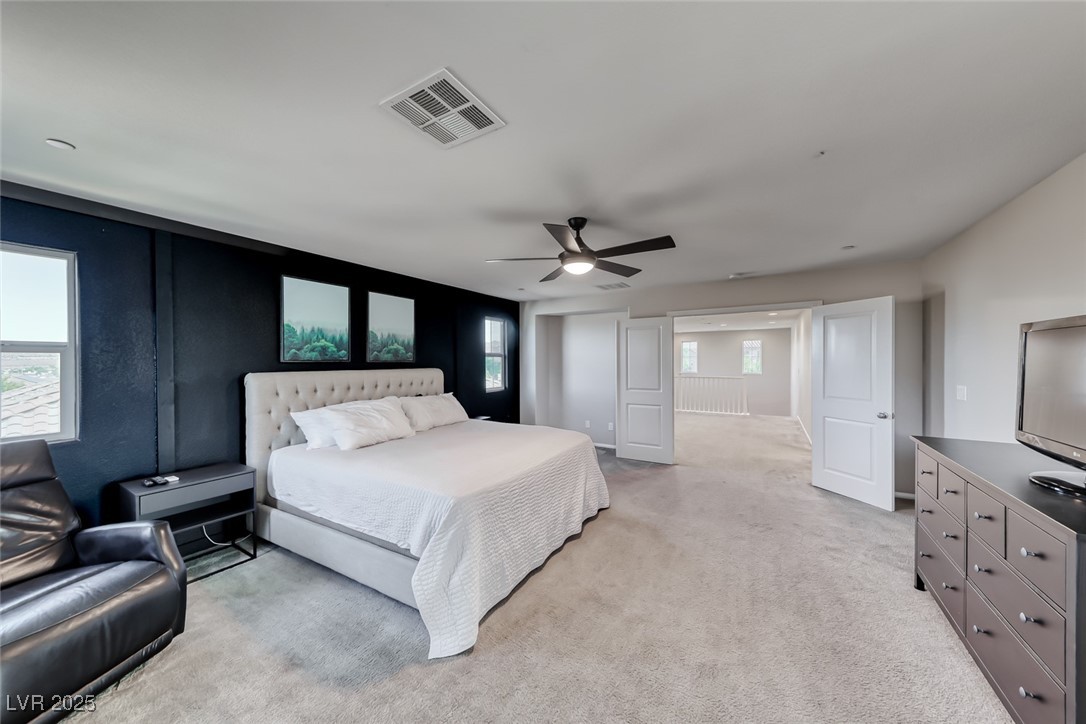 723 Gorringe Ridge Court Henderson, NV 89002 - Photo 24 of 48 Bedroom featuring light carpet and a ceiling fan