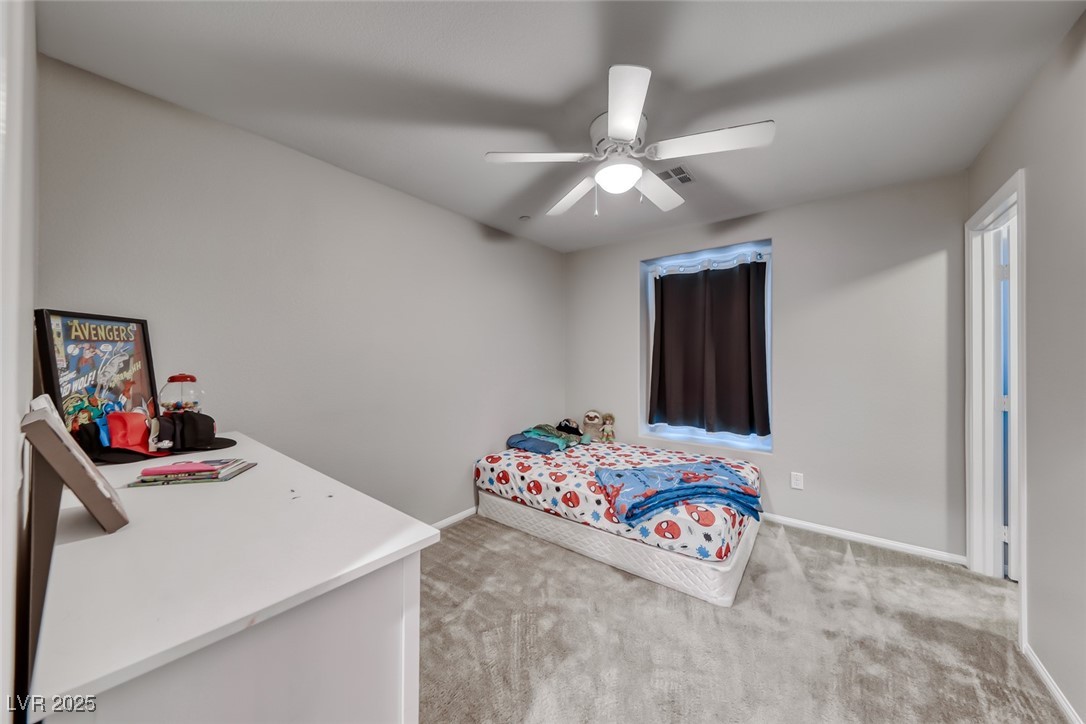 723 Gorringe Ridge Court Henderson, NV 89002 - Photo 30 of 48 Bedroom with light colored carpet and ceiling fan