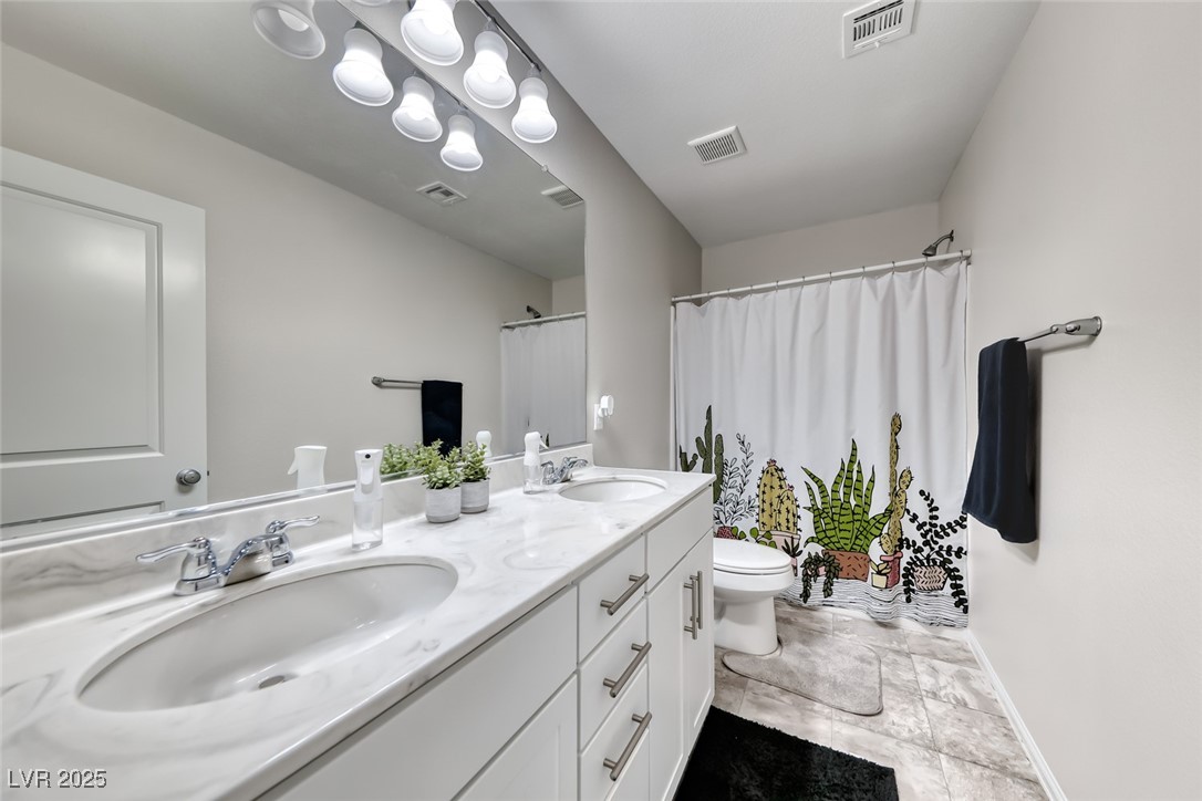 723 Gorringe Ridge Court Henderson, NV 89002 - Photo 31 of 48 Bathroom featuring double vanity and a shower with shower curtain