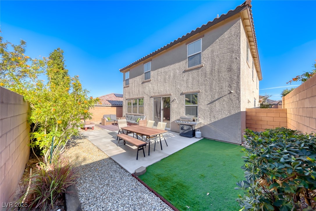 723 Gorringe Ridge Court Henderson, NV 89002 - Photo 37 of 48 Back of house with a fenced backyard, a patio area, stucco siding, and a tiled roof