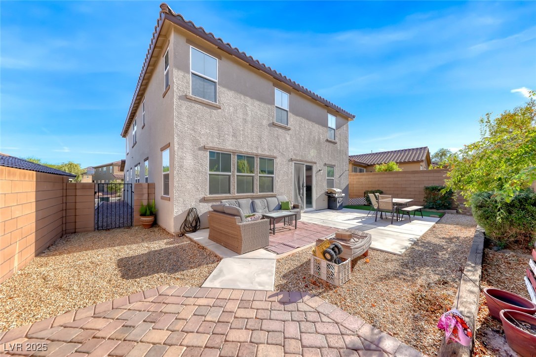 723 Gorringe Ridge Court Henderson, NV 89002 - Photo 39 of 48 Rear view of property featuring a fenced backyard, a patio, a gate, outdoor lounge area, and stucco siding