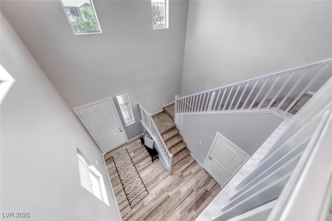 723 Gorringe Ridge Court Henderson, NV 89002 - Photo 4 of 48 Staircase featuring a towering ceiling and wood finished floors