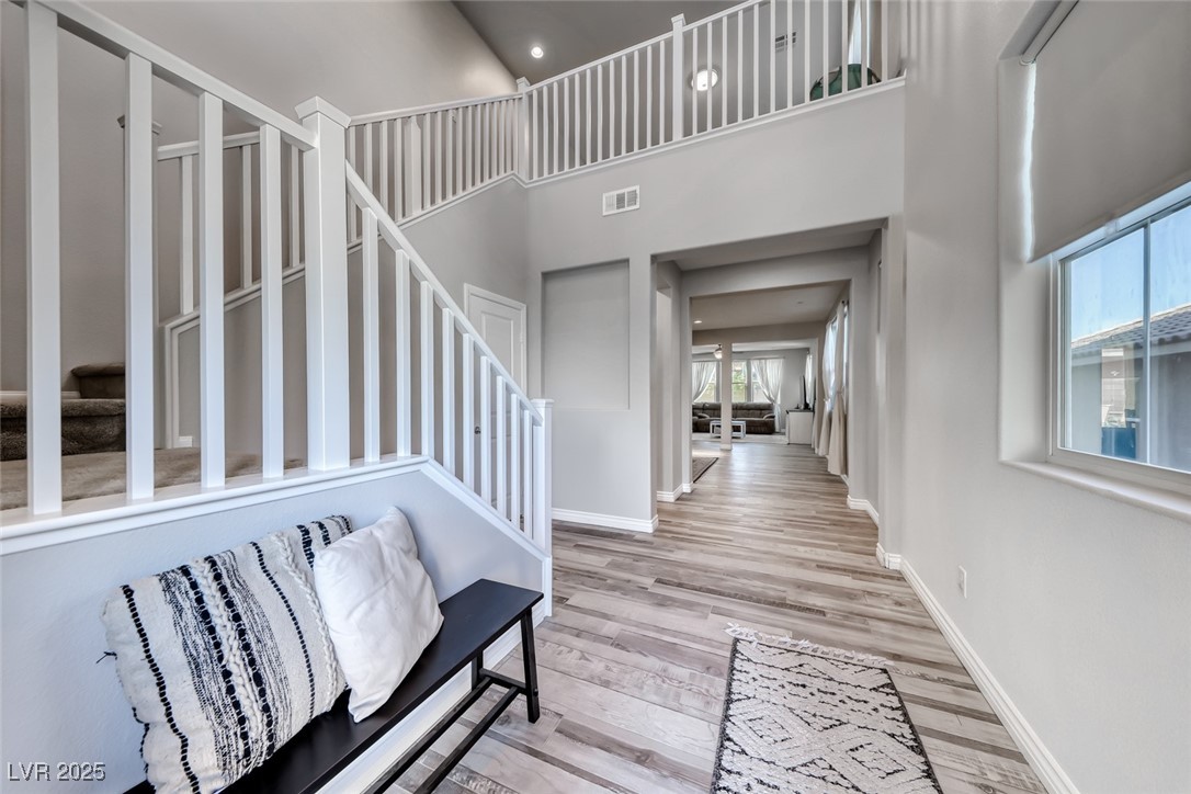 723 Gorringe Ridge Court Henderson, NV 89002 - Photo 5 of 48 Entryway with stairs, a high ceiling, light wood-style flooring, and recessed lighting