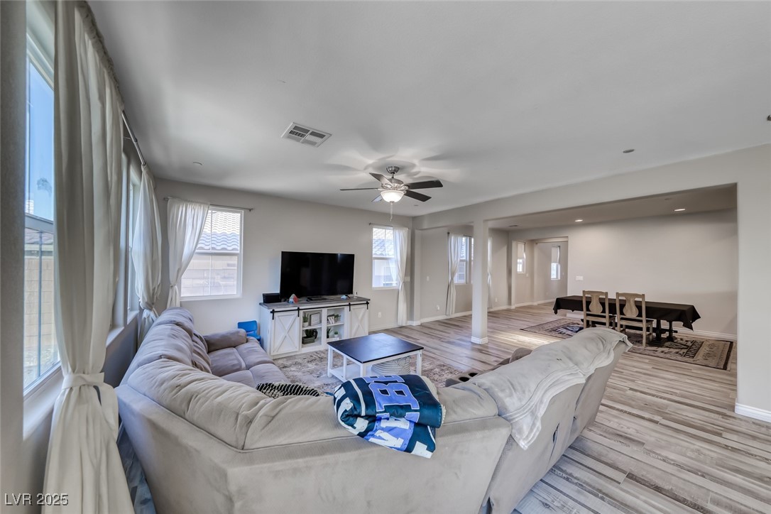 723 Gorringe Ridge Court Henderson, NV 89002 - Photo 6 of 48 Living area featuring light wood-style flooring and a ceiling fan