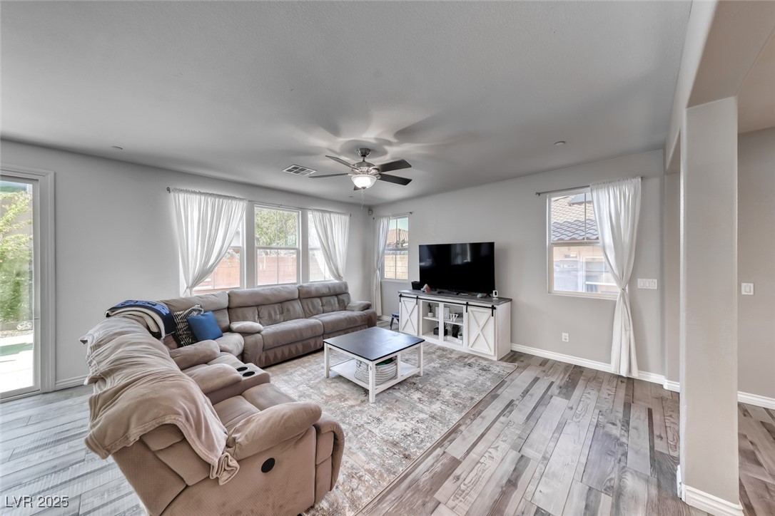 723 Gorringe Ridge Court Henderson, NV 89002 - Photo 8 of 48 Living room with light wood-type flooring and ceiling fan