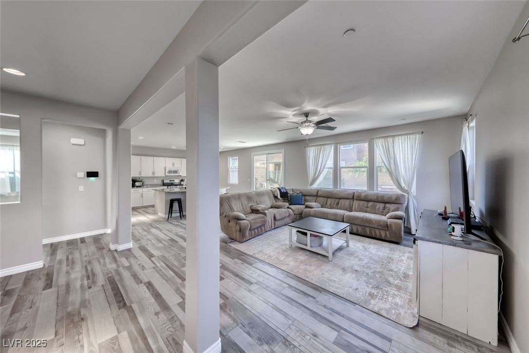 723 Gorringe Ridge Court Henderson, NV 89002 - Photo 9 of 48 Living room with a ceiling fan, light wood-type flooring, and recessed lighting