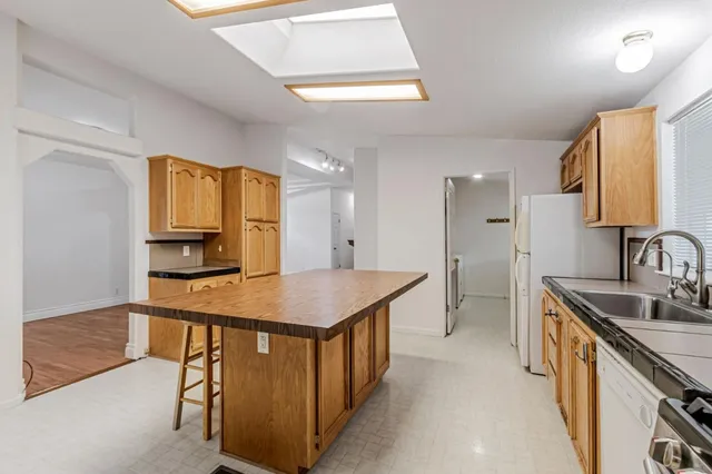 a kitchen that has a lot of cabinets in it and wooden floors