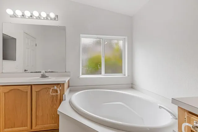 a bathroom with a bathtub and a sink