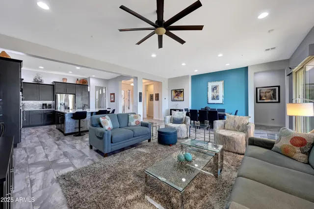 a kitchen with stainless steel appliances kitchen island granite countertop a sink refrigerator and cabinets