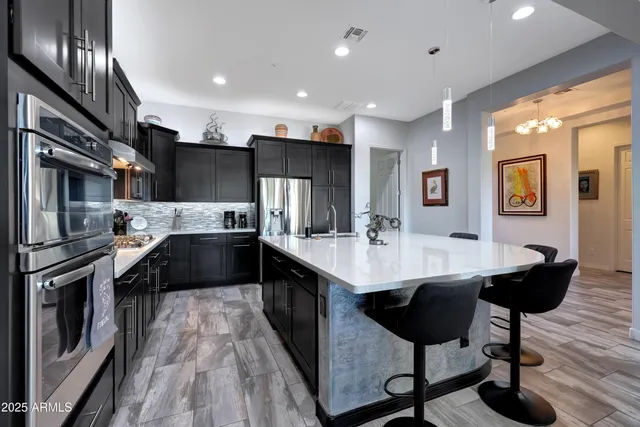 a kitchen with stainless steel appliances a refrigerator and microwave