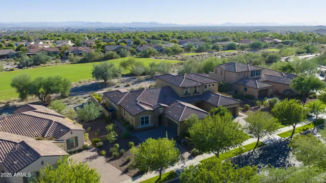 an aerial view of a house with a yard