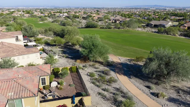 a view of a house with a swimming pool and a yard