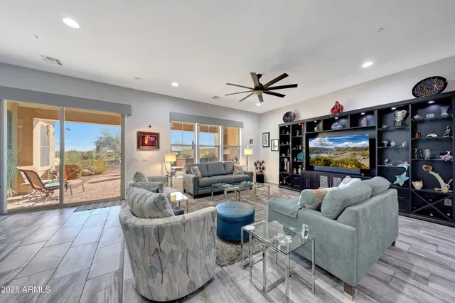 a living room with furniture kitchen view and a chandelier